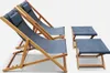 Two wooden deck chairs and two matching footrests are arranged on a white background. Produktbild-Vorschau