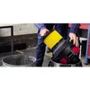 A person is holding a yellow filter over a vacuum cleaner canister. Náhled obrázku produktu