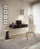 A modern home office setup with a floating desk, laptop, chair, and decorative elements. Produktbild-Vorschau