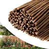 A collage showing a close-up of a rolled-up bamboo fence and a garden scene with a brick wall and flowers. Produktbild-Vorschau