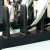 Close-up of a black dish rack holding stainless steel pot lids. Náhled obrázku produktu