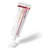 A tube of cream with some cream squeezed out onto a white surface. Voir les images du produit