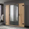 A four-door wardrobe with mirrored doors and wooden accents, set against a gray wall and on a fluffy rug. Produktbild-Vorschau