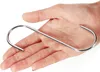 A hand holding an S-shaped metal hook. Produktbild-Vorschau