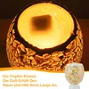 A close-up of a decorative mosaic glass oil diffuser with a warm light emanating from within, accompanied by German text describing its scent diffusion properties. Produktbild-Vorschau