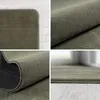 A collage of four close-up images showing the texture and details of a green rug. Produktbild-Vorschau