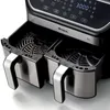 Close-up of the top and front of a black and silver dual-basket air fryer. Podgląd zdjęcia produktu