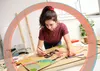 A young woman is drawing on a large piece of cardboard with markers. Náhled obrázku produktu