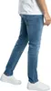 A person wearing blue jeans and white sneakers, shown from the waist down, against a white background. Produktbild-Vorschau