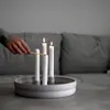 A hand lighting candles on a candle holder. Produktbild-Vorschau
