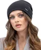 A woman wearing a beanie and a coat. Produktbild-Vorschau