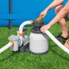 A person is shown operating a sand filter pump system next to a blue swimming pool. Produktbild-Vorschau