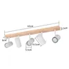 A product image showing a wooden bar with five white spotlights attached, with dimensions indicated by text and lines. Produktbild-Vorschau
