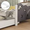 A close-up view of a child's bed with a drawer and a decorative headboard. Náhľad obrázku produktu