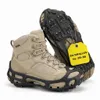 A pair of beige hiking boots with black ice cleats attached to the soles, displayed on a white background. Produktbild-Vorschau
