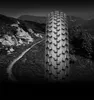 A close-up of a bicycle tire tread is superimposed over a mountainous landscape with a winding trail. Náhled obrázku produktu