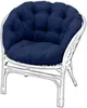 A navy blue cushion on a white rattan chair. Produktbild-Vorschau