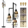 A black industrial-style floor lamp with three hanging lights, each with a metal cage and jute-wrapped shade. The image also shows three Edison-style LED bulbs and three smaller inset images of the lamp lit in different settings. Produktbild-Vorschau