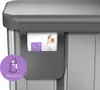 A close-up view of a trash can's liner pocket feature, showing a hand pulling out a trash bag. Podgląd zdjęcia produktu