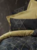 A close-up view of bedding with a geometric pattern. Produktbild-Vorschau