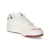 A white and beige sneaker with red accents is shown against a white background. Anteprima dell’immagine prodotto