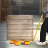 A person is using a yellow furniture dolly with a large wooden crate on it in a warehouse setting. Podgląd zdjęcia produktu