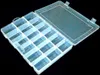 An open, transparent plastic organizer box with multiple compartments, shown against a black background. Produktbild-Vorschau