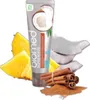 A tube of toothpaste is surrounded by ingredients like pineapple, coconut, and cinnamon sticks. Anteprima dell’immagine prodotto