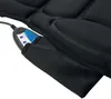 A close-up view of a black massage mat with a control unit in a pocket. Produktbild-Vorschau