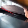 A hand is spraying lubricant onto a treadmill belt. Podgląd zdjęcia produktu
