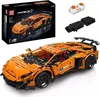 An orange remote-controlled car model kit and its accessories are displayed on a white background. Voir les images du produit