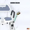 A close-up view of a shower chair with a shower head holder and shower head attached, against a marble-patterned wall. Produktbild-Vorschau