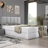 A bedroom scene featuring a bed with a headboard, mattress, and topper, along with decorative items and a rug. Produktbild-Vorschau