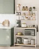 A modern kitchen scene with a white tiled backsplash, sage green cabinets, and a white shelving unit filled with kitchen appliances and decor. Náhled obrázku produktu