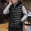 A man wearing a black heated vest over a gray turtleneck sweater. Náhľad obrázku produktu