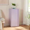 A lilac metal cabinet with sliding doors stands in a room with a chair and a plant. Voir les images du produit