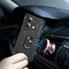 A person is holding a black phone case with a ring holder, about to attach it to a magnetic car mount attached to a car's air vent. Produktbild-Vorschau