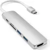 A silver USB-C hub with multiple ports and a white cable connected to a USB-C connector, shown on a white background. Voir les images du produit