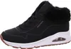 A side view of a black Skechers sneaker with a white sole and brown accents. Voir les images du produit