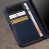 Close-up of a blue leather wallet case with cards and money inside. Produktbild-Vorschau