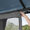 A hand is shown adjusting a gray curtain with a mesh window, attached to a dark metal frame of a gazebo. Podgląd zdjęcia produktu