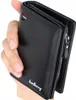 A hand holds a black wallet. Podgląd zdjęcia produktu