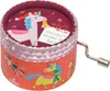 A circular music box with Christmas-themed unicorn illustrations and a winding crank. Produktbild-Vorschau