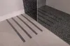Anti-slip strips applied to a tiled floor in a bathroom, near a shower enclosure. Náhľad obrázku produktu