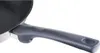 A close-up shot of the handle of a frying pan. Voir les images du produit