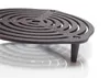 A close-up shot of a black cast iron grate with a spiral design and three legs, resting on a white surface with a reflection. Produktbild-Vorschau