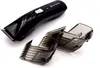 A black Remington hair clipper with two gray comb attachments on a white background. Anteprima dell’immagine prodotto