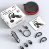 A product shot of a Bluetooth headset and its accessories, including the packaging, charging cable, and ear tips, arranged on a light gray surface. Produktbild-Vorschau