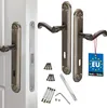 A set of door handles and related hardware, including screws and an Allen key, displayed against a white background. A blue tag with 'MADE IN EU' is attached to one of the handles. Podgląd zdjęcia produktu