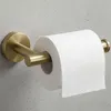 A close-up shot of a gold toilet paper holder mounted on a gray wall, with a roll of toilet paper on it. Produktbild-Vorschau